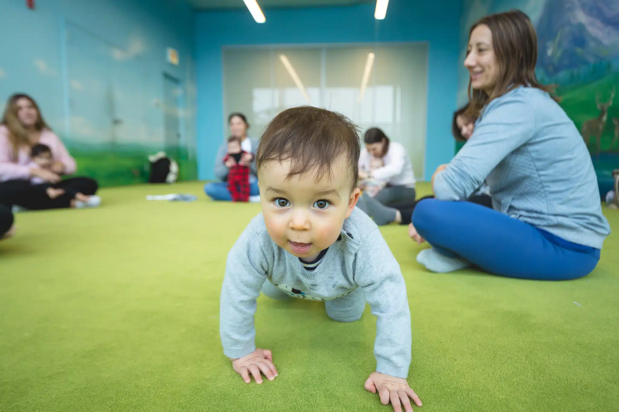 Baby crawling in music class at Bubbles Academy